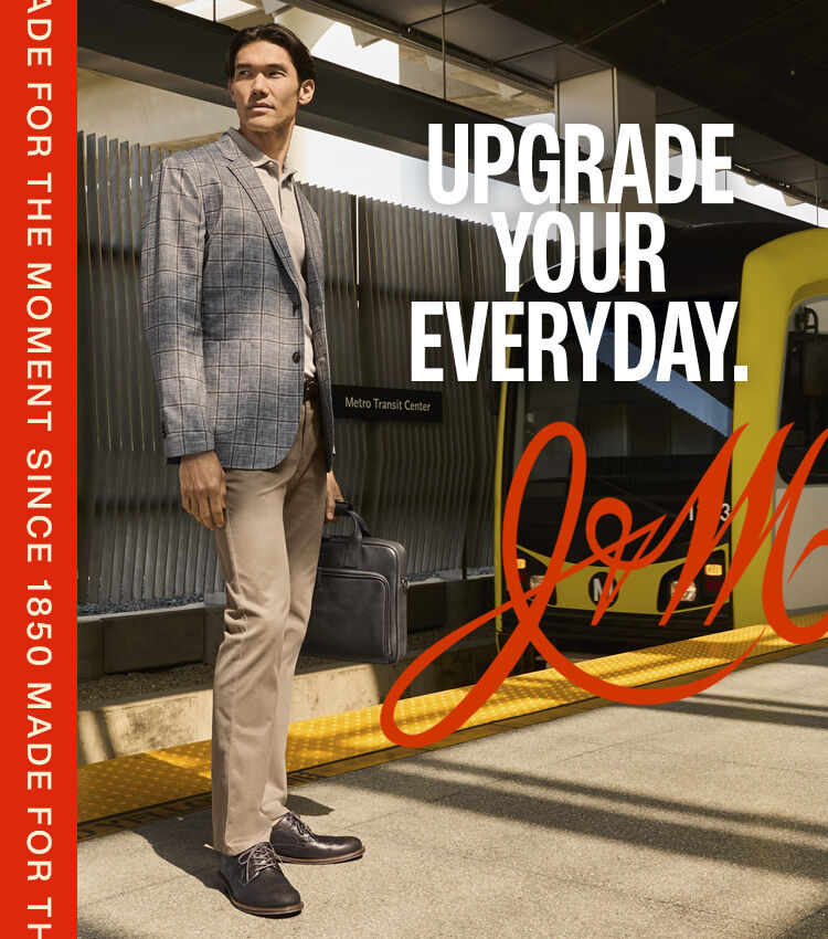 Man wearing a plaid blazer and neutral trousers at a train station, alongside a second image of him wearing the blazer aboard a train. Text reads &lsquo;Upgrade Your Everyday.'